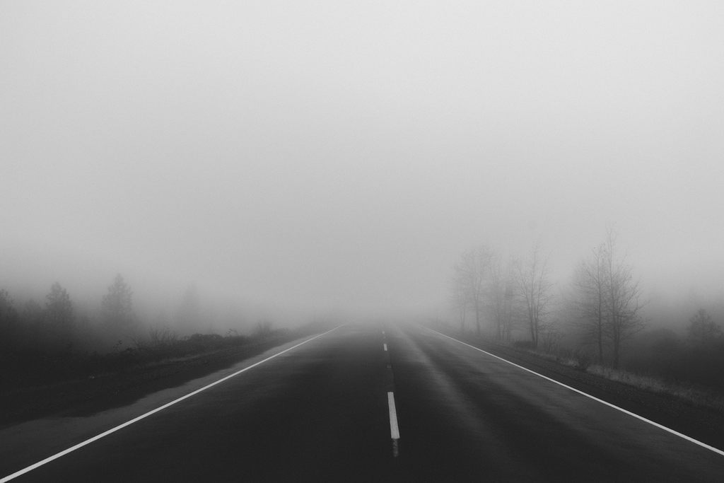 A long road covered in thick fog.