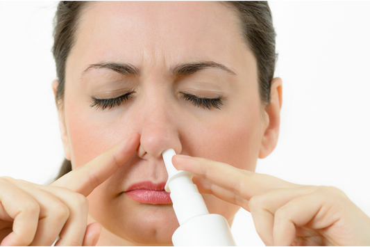 A woman using nasal spray.