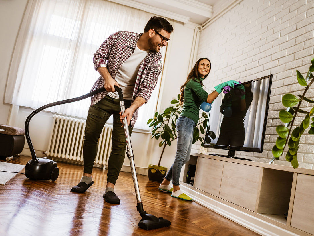 Young couple cleaning their home